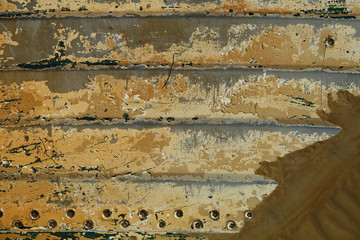 hull detail of weathered abandoned alumium boat on beach