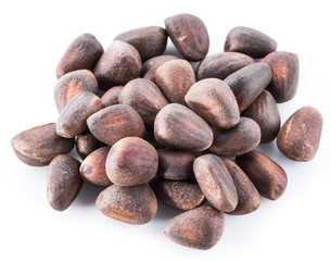 Unshelled pine nuts on the white background. Organic food.