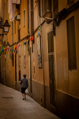 Italian alley. A woman walks away