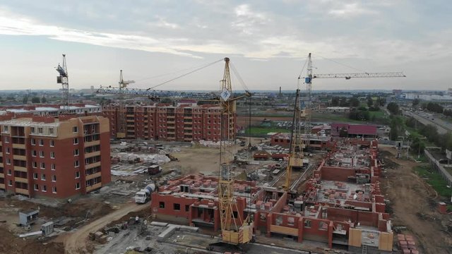 4k Aerial view of the city. Tower cranes working at a construction site