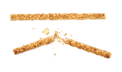 salty broken cracker pretzel sticks with sesame isolated on white background, top view