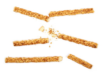salty broken cracker pretzel sticks with sesame isolated on white background, top view