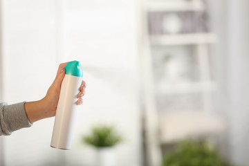 Woman spraying air freshener at home - obrazy, fototapety, plakaty