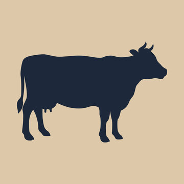 Sign cow. Isolated silhouette cow on beige background. Vector illustration
