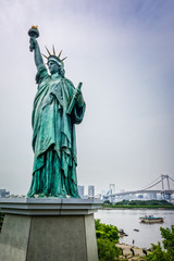 Statue of liberty and tokyo cityscape, Japan