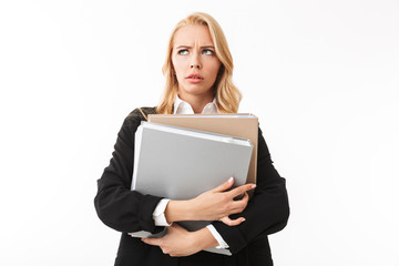 Photo of manager girl wearing office suit holding paper folders in hands, isolated over white background in studio