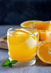 Fresh natural orange juice with a mint leaf