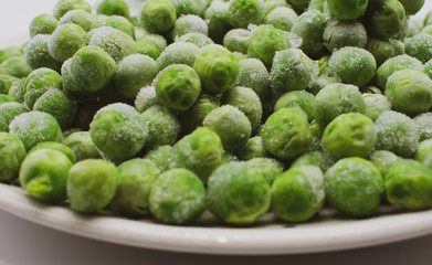 Frozen garden peas on dish