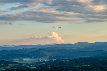 Fototapeta na wymiar Glider flying over mountains in Bezmiechowa Gorna, Poland. 29-07-2016