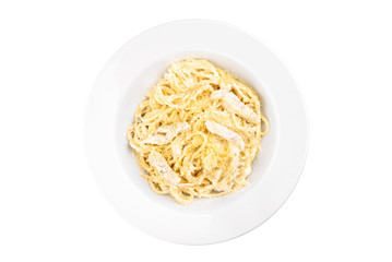 Spaghetti with chicken in dairy sauce in a white plate isolated on white background. top view. flat lay