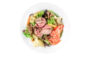 Salad with meat, pear, tomato, on a white plate isolated on white background isolated on white background. top view. flat lay
