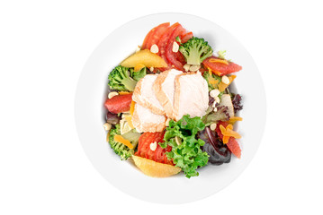Salad with chicken fillet, tomato, nuts, broccoli and orange in a white plate isolated on white background. top view. flat lay