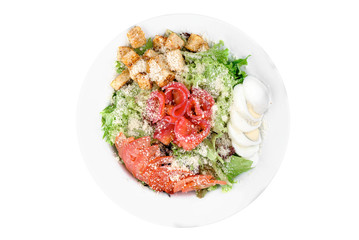 Caesar salad with salmon in a white plate isolated on white background. top view. flat lay