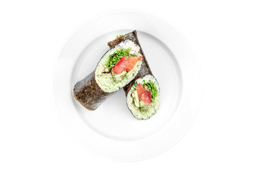 sushi burrito with salmon and cucumber in a white plate isolated on white background. top view. flat lay