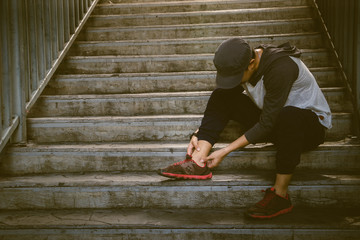 Runner man holding ankle in pain. Athlete runner training accident.