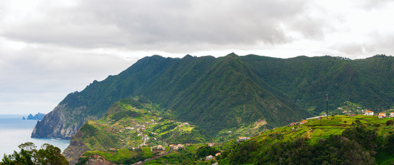Fototapeta na wymiar Mountain landscape. View of mountains and sea on route Vereda da Penha de Aguia, Madeira Island, Portugal, Europe.