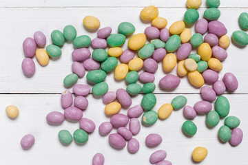 Colorful candies on wooden background