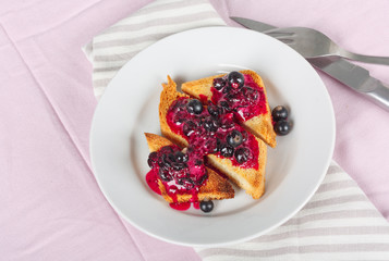 Delicious toasts bread with homemade currant jam with fork and knife