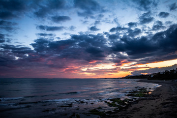 Sunset by the sea. The clouds are painted in beautiful colors.