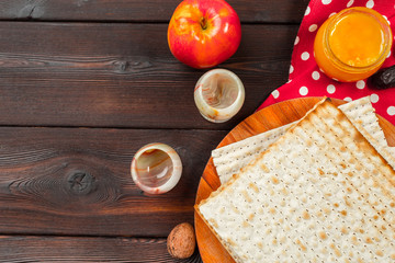 Jewish holiday Passover banner design with wine, matzo on wooden background.