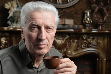 Portrait of beautiful senior man drinking tea
