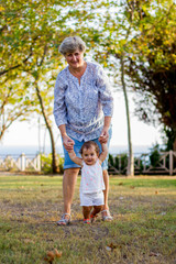 Young grandmother and grandfather on a walk with their granddaughter