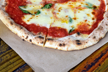 Pizza Margherita on rustic wooden table
