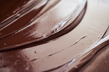 Glistening melted chocolate spread out on a table