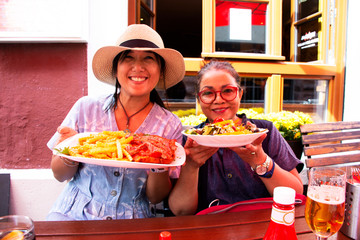 Asian thai women mother and daughter travel show german food before eat at local restaurant in Heidelberg, Germany