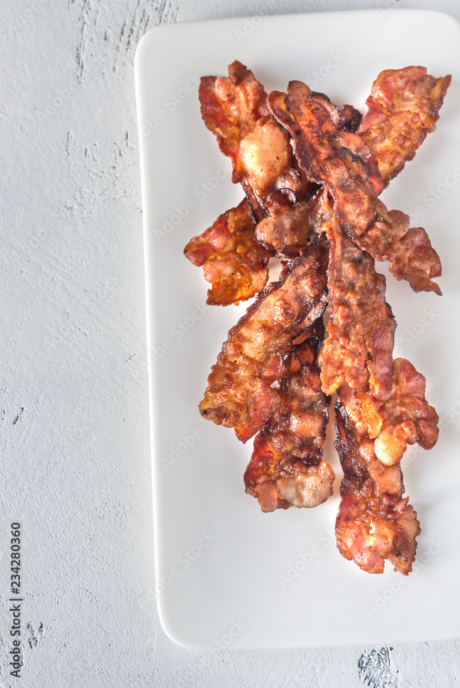 Canvas Prints Fried bacon strips on the white plate