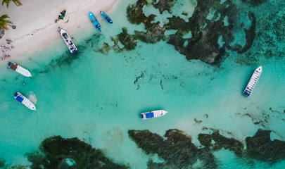 Boats on the sea. The boat is floating on the emerald clear sea between coral reefs. Aerial view