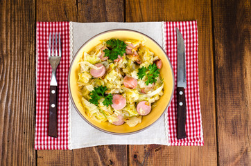 Stewed cabbage with slices of sausages