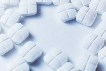 Top view of the Spilled square white pills on the white surface - Powered by Adobe
