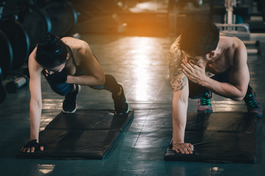 Two people sporty put your hands on the floor and hold the shoulder for fitness workout.