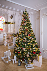 Christmas tree decorated with golden balls and red bows
