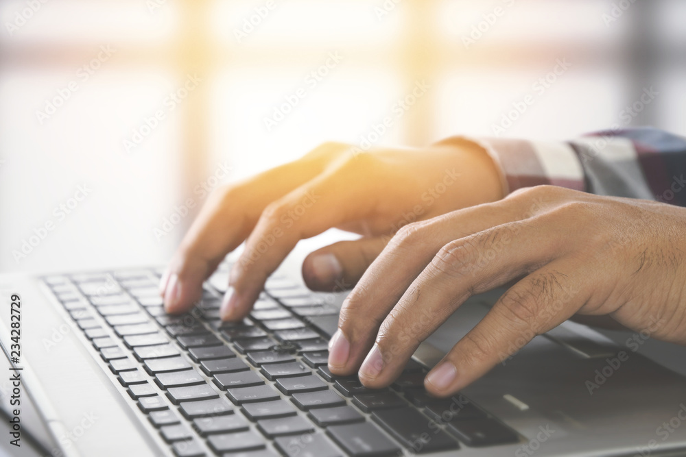 Poster man hands typing on a laptop keyboard on a desk, website developer, people and technology concept