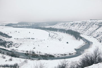 winter landscape , aerial view of river and snowy hills