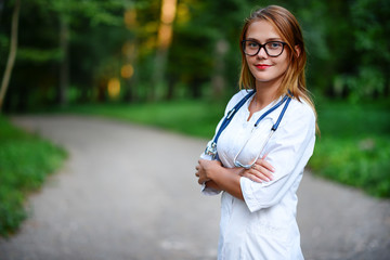 It looks beautiful. a young girl who is a doctor stands outside,