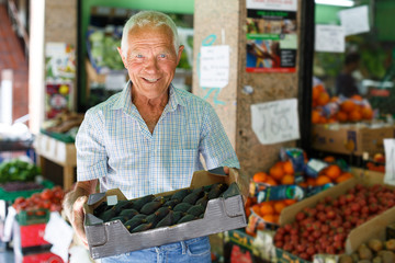 Man searching for fruits in greengrocery