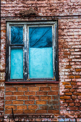 old wooden window in an old brick wall