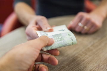 The money is handed over for the cash purchases, Czech banknotes