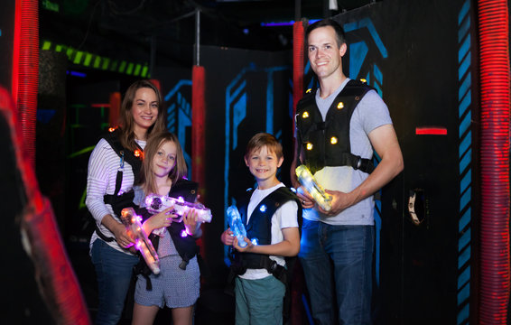 Parents and children playing laser tag