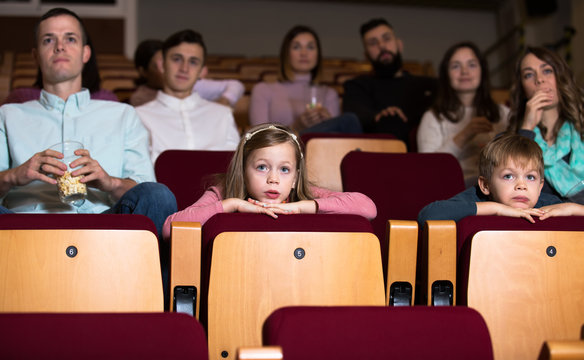 People eating popcorn in cinema