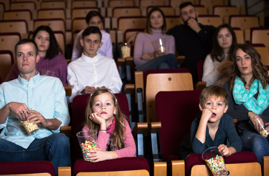 People eating popcorn in cinema
