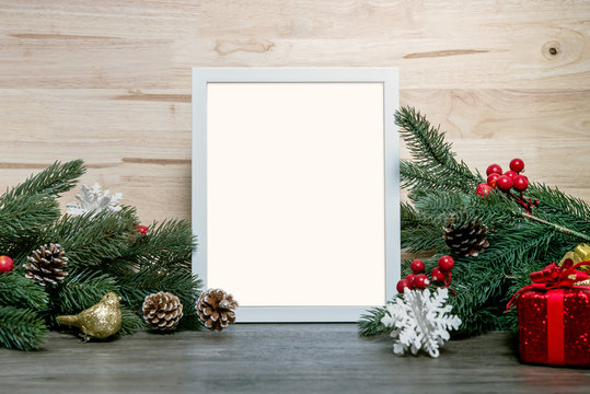 Christmas holiday greeting frame design mockup with decoration on wood table.