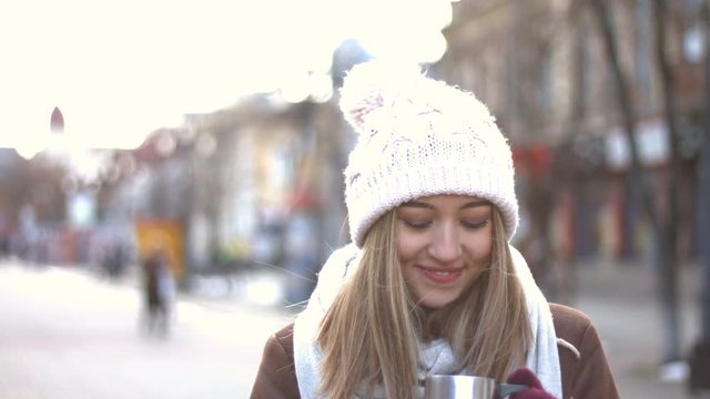 Fabulous smile.
Girl stands on the Arbat, wind blows in the face. She drinks hot drink. She looks great with her fabulous smile. Winter.