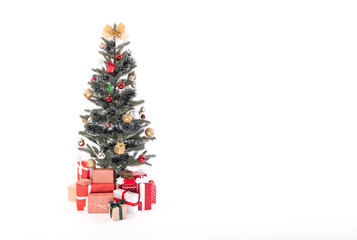 Decorated Christmas tree with gift wrapped presents isolated on a white background.