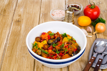 Ragout of vegetables in bowl on wooden table