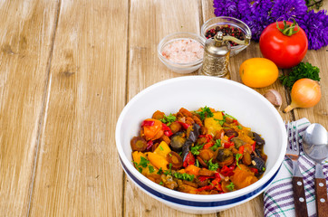 Ragout of vegetables in bowl on wooden table