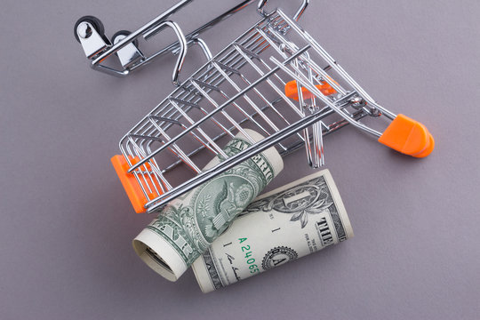 Shopping cart and One Dollar paper currency